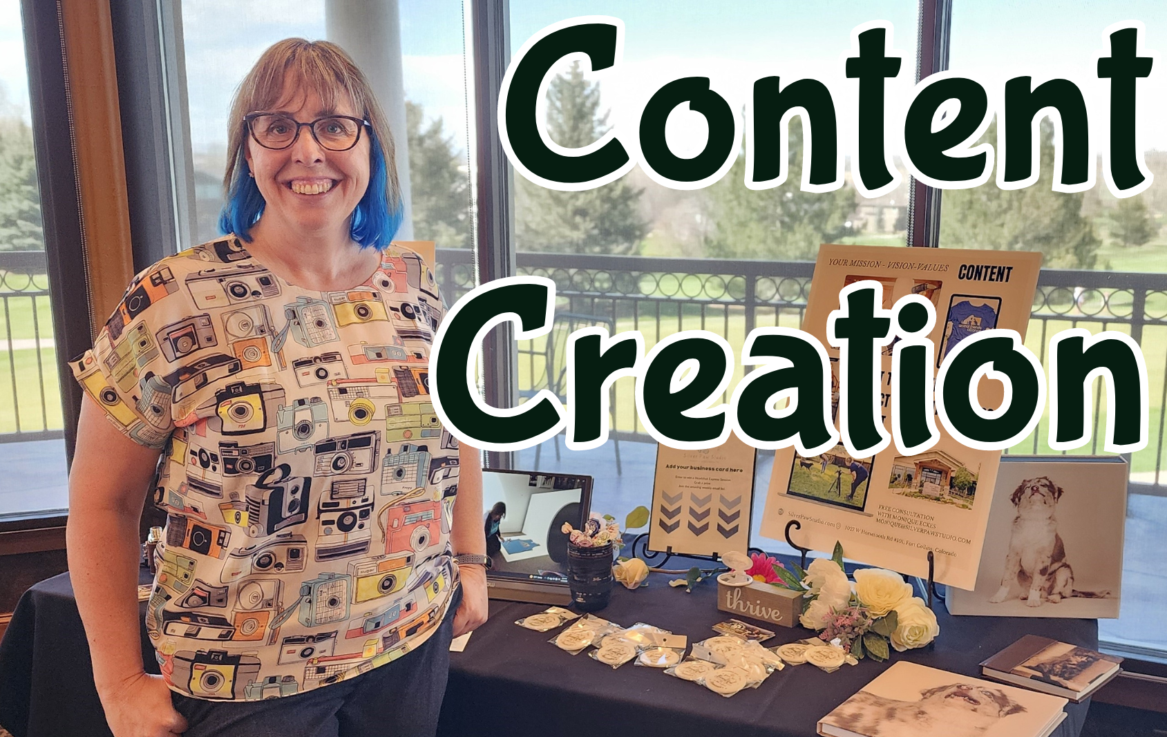 content creation blog header Monique Eckes wearing a camera print shirt standing at her vendor table at the eWomen Network Success Summit